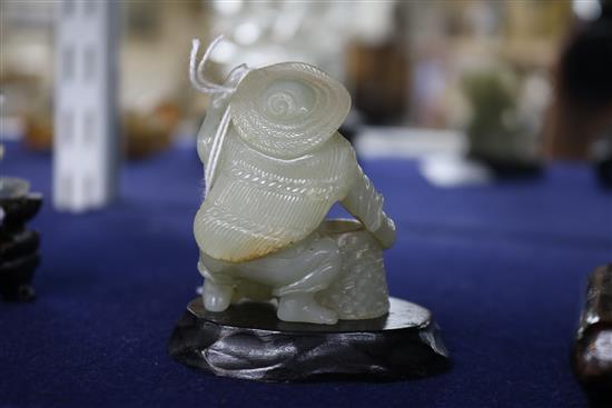 Two Chinese celadon jade figures of a fisherman and a lion-dog, 6.2 and 11cm, wood stands